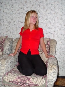 She is a stunning woman and is dressed in red and black.