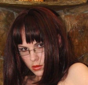 She appears hot and seductive as she sits.