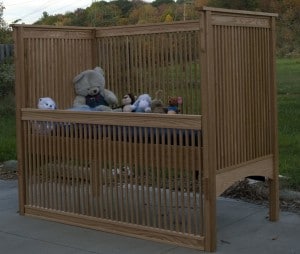 A wooden crib and toys were present.
