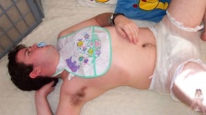 A mature sissy He is lying for the photo shoot and wearing a diaper.