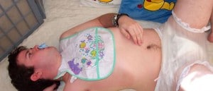 A mature sissy He is lying for the photo shoot and wearing a diaper.