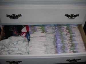 A diaper cabinet There appear to be numerous diapers in the cabinet.