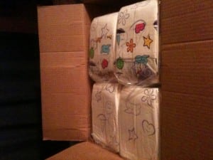 There were many packages of diapers in the box.