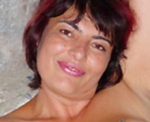 A woman doing an underarm clean is standing in front of the photo shoot.