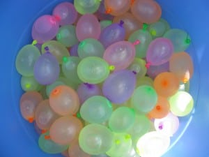 There were numerous balloons in a water balloon tub.