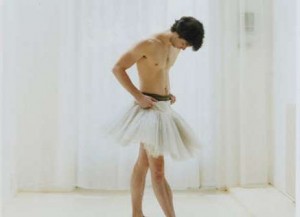 Standing and looking hot and seductive is a man.
