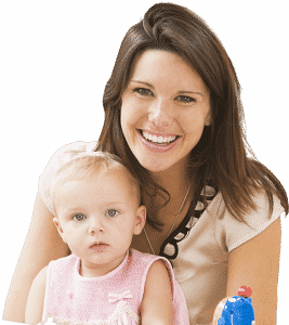 A cheerful woman is holding the infant while donning a lovely attire.