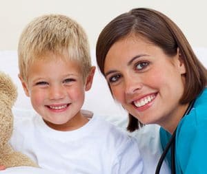 He is also accompanied by a patient boy who is seated next to the doctor on a bed in the hospital.