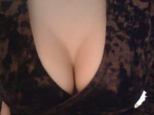 The image displays a top view of the cleavage, which is attractive and seductive.