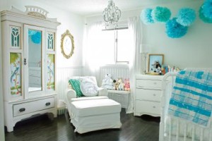 A stunning room It was all white, and there was a sofa, baby cradle, and cabinet.