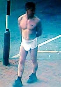 Standing and sporting the diaper, the man has a gorgeous and seductive appearance.