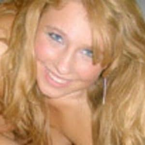 A panty mommy is lying in bed, looking hot and seductive while exposing her lovely boobs.
