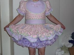 A man is dressed in gorgeous clothes and he appears to be quite seductive.