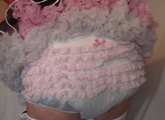 Bending over, a lovely girl reveals her sexy diaper.