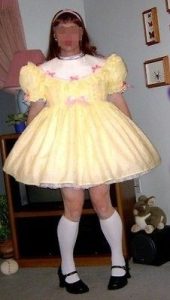 Standing and wearing yellow dresses, a seductive woman.