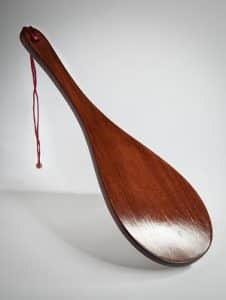 A wooden paddle for spanking It was brown, and he looked incredibly hot and seductive.