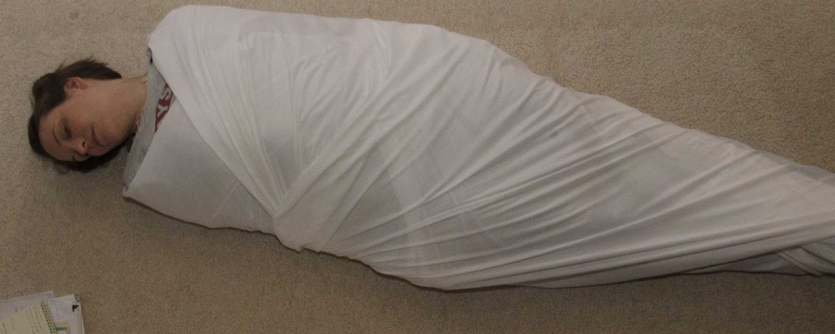 A Fetish Milf Mommy Swaddle is on the ground and appears to be tied.