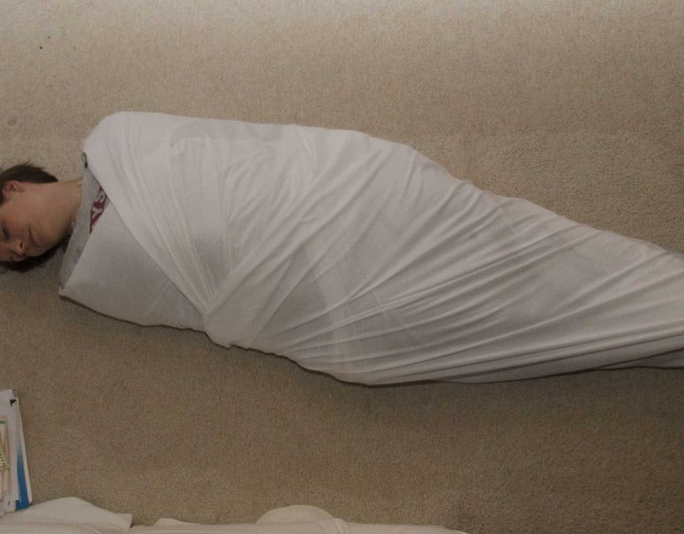 A Fetish Milf Mommy Swaddle is on the ground and appears to be tied.