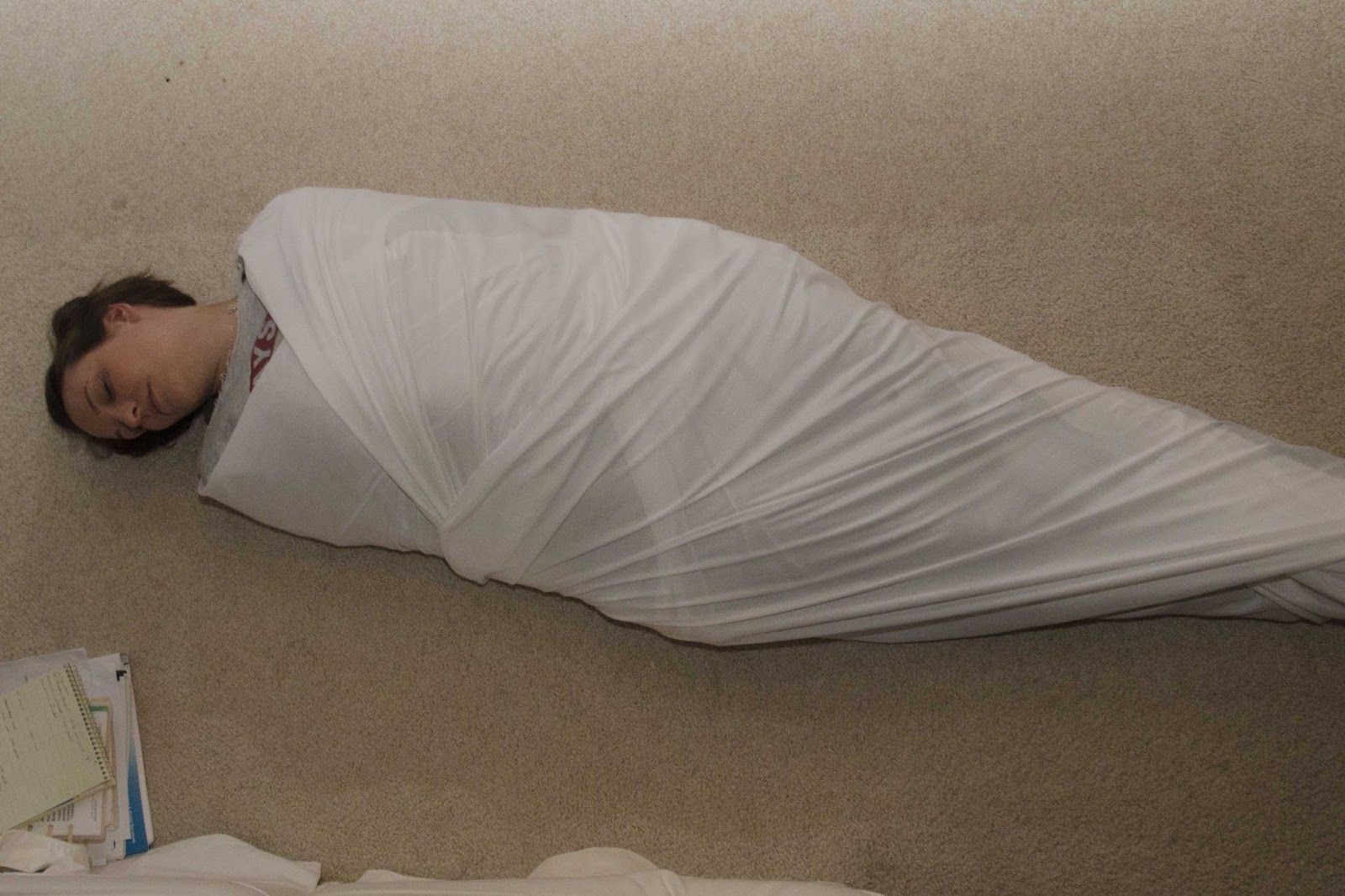 A Fetish Milf Mommy Swaddle is on the ground and appears to be tied.