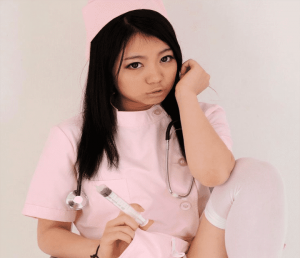 A nurse girl is standing, looking seductive, and experiencing injection.