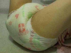 The diaper is being worn by a lovely female, who is displaying her sexy diaper.