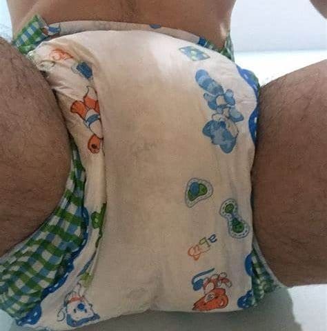 A Huge Diaper Guy He is seated on the ground and exposing his diaper area.