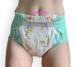 The diaper The diaper-wearing fetishist is standing with the green diaper on.