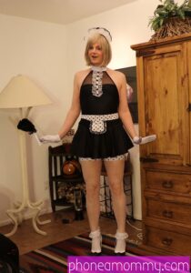 Standing in front of the photo session is a Sissy Training woman wearing the black attire.