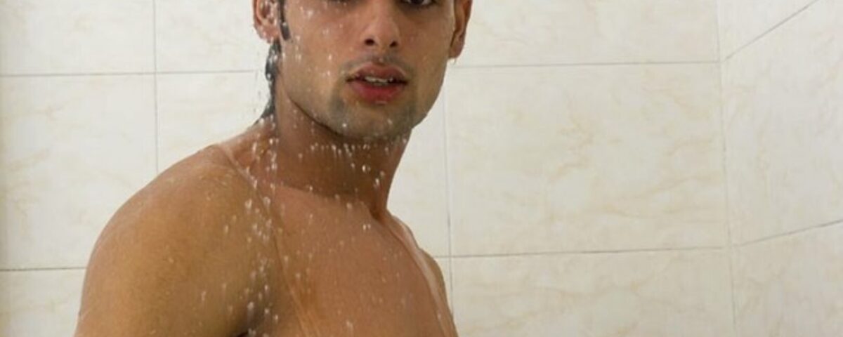A shower man, he is standing while taking a shower and bathing.
