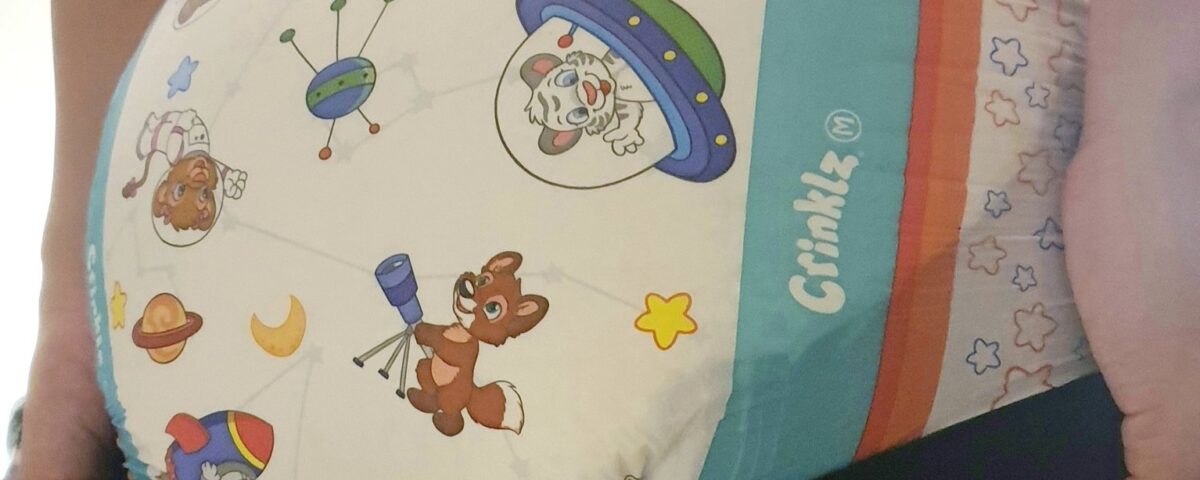 A sexy lad wearing a diaper is doing the backwards-turning stance.