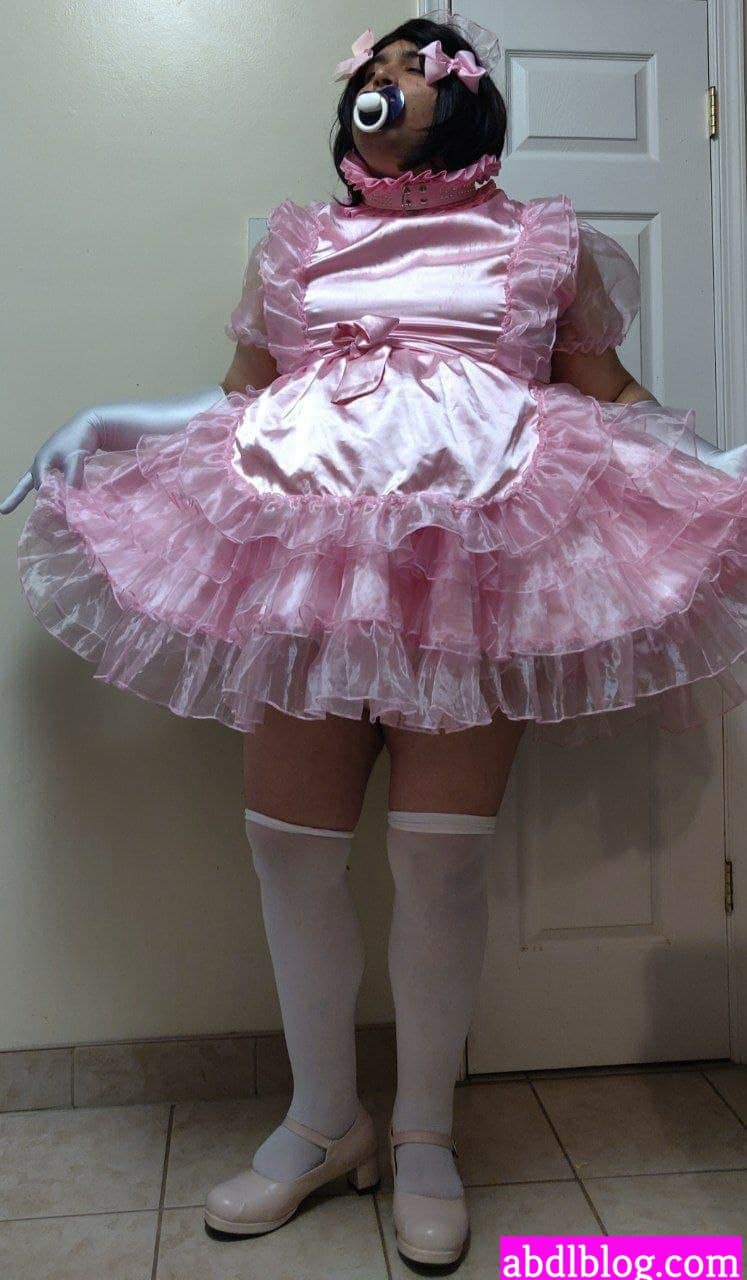 In the picture, there is a man wearing a gorgeous diaper and standing.